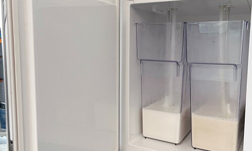 Refrigerator of a coffee machine with two different types of milk