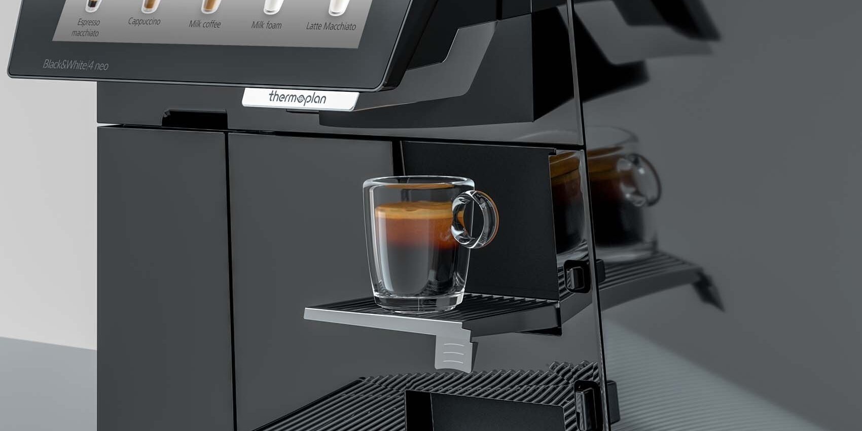 Espresso on cup grid in front of a black coffee machine