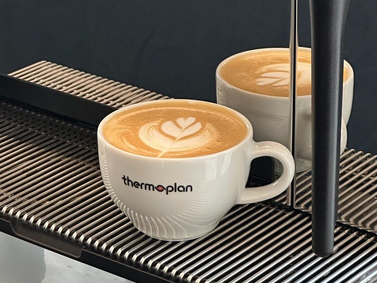 Black fully automatic coffee machine with steam lance in front Latte Art Cappuccino